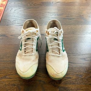 New Balance Metal cleats green and white. In good used condition.